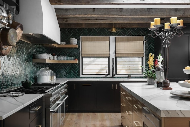 713 E 32nd St, Austin, TX 78705 - kitchen with stainless steel range, tasteful backsplash, light wood-style floors, and light stone counters