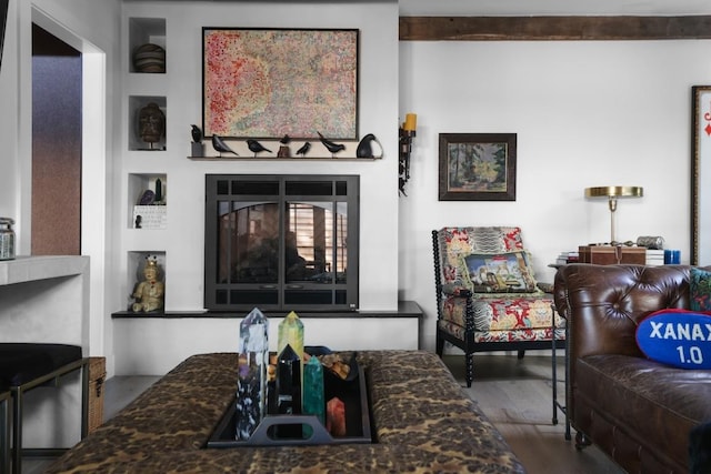 713 E 32nd St, Austin, TX 78705 - living room featuring wood finished floors, a glass covered fireplace, and beamed ceiling