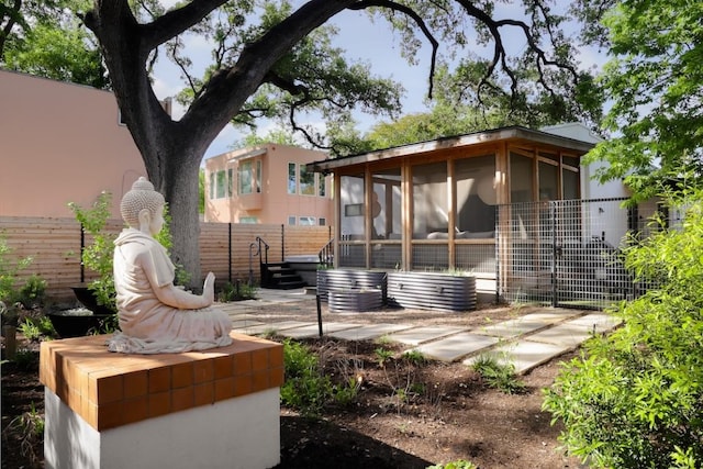 713 E 32nd St, Austin, TX 78705 - rear view of house featuring a sunroom and fence