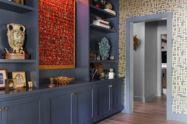 713 E 32nd St, Austin, TX 78705 - indoor dry bar featuring wood finished floors, wallpapered walls, and baseboards