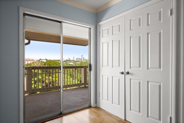 2450 Wickersham Ln Unit M1318, Austin, TX 78741 - doorway to outside featuring ornamental molding and wood finished floors