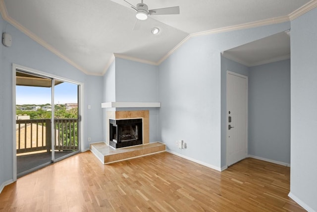 2450 Wickersham Ln Unit M1318, Austin, TX 78741 - unfurnished living room with lofted ceiling, a tile fireplace, wood finished floors, crown molding, and ceiling fan