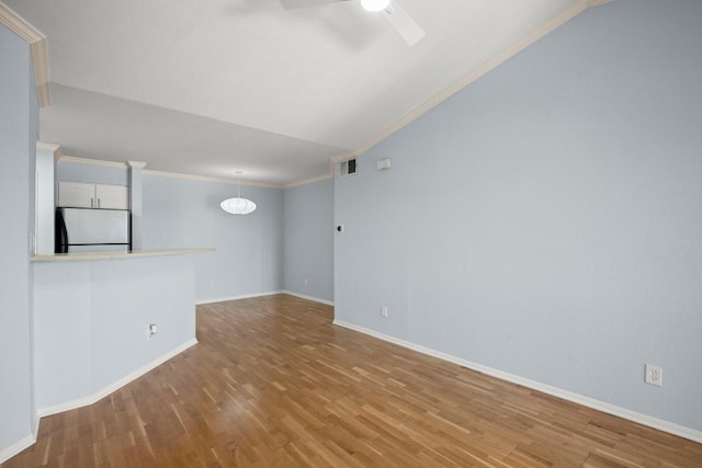 2450 Wickersham Ln Unit M1318, Austin, TX 78741 - empty room with a ceiling fan, wood finished floors, baseboards, crown molding, and lofted ceiling