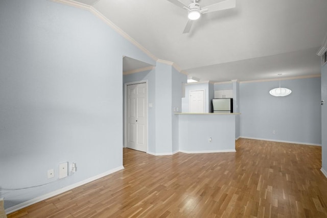 2450 Wickersham Ln Unit M1318, Austin, TX 78741 - unfurnished living room with vaulted ceiling, a ceiling fan, wood finished floors, ornamental molding, and baseboards