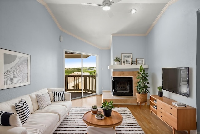 2450 Wickersham Ln Unit M1318, Austin, TX 78741 - living area featuring lofted ceiling, ornamental molding, ceiling fan, wood finished floors, and a fireplace with raised hearth