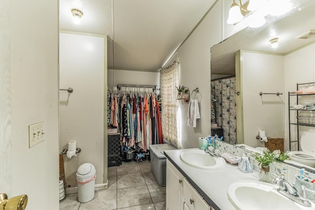 116 Hokanson Rd, Del Valle, TX 78617 - full bathroom with double vanity, tile patterned flooring, and a spacious closet