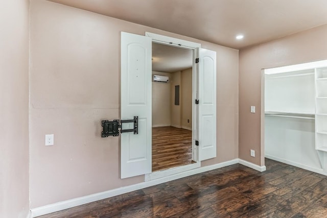 116 Hokanson Rd, Del Valle, TX 78617 - spare room featuring wood finished floors, a wall mounted AC, and recessed lighting