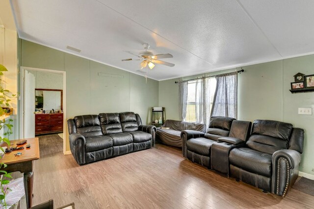 116 Hokanson Rd, Del Valle, TX 78617 - living room featuring vaulted ceiling, crown molding, wood finished floors, and ceiling fan