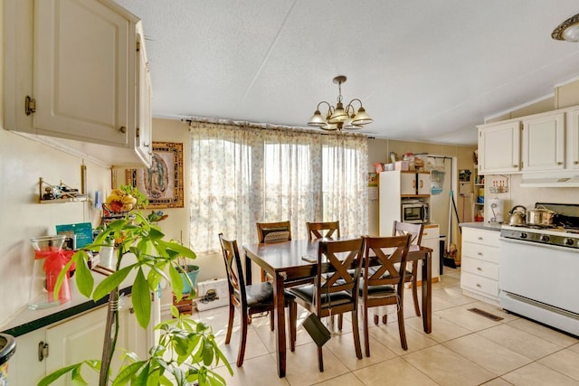 116 Hokanson Rd, Del Valle, TX 78617 - dining area featuring a chandelier, light tile patterned floors, and a textured ceiling