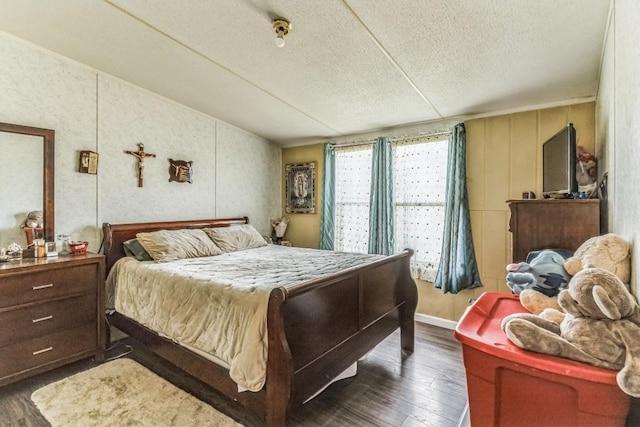 116 Hokanson Rd, Del Valle, TX 78617 - bedroom with wood finished floors, a textured ceiling, and vaulted ceiling