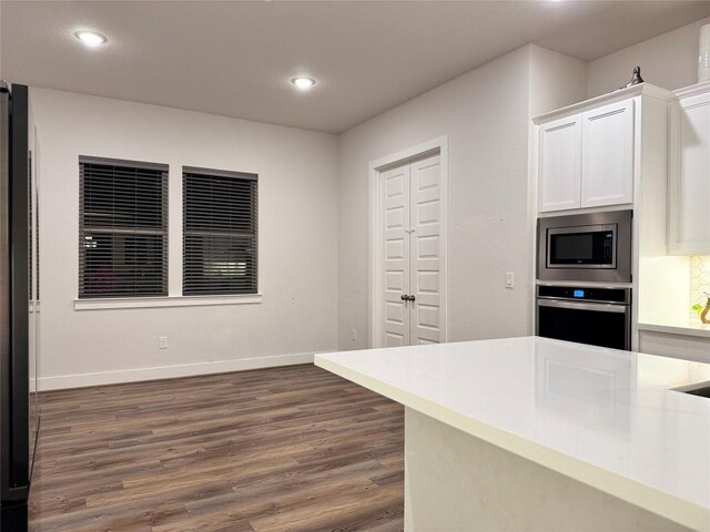 1162 Thicket Ln, New Braunfels, TX 78132 - kitchen with appliances with stainless steel finishes, dark wood finished floors, white cabinets, light countertops, and recessed lighting