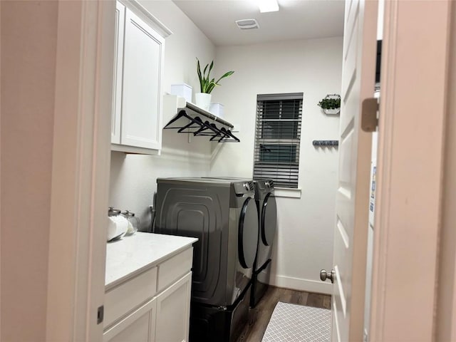 1162 Thicket Ln, New Braunfels, TX 78132 - washroom with washing machine and clothes dryer, cabinet space, dark wood-style flooring, and baseboards