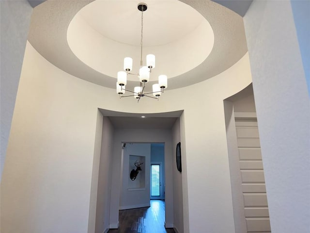1162 Thicket Ln, New Braunfels, TX 78132 - hallway featuring a chandelier, a raised ceiling, and dark wood-style floors