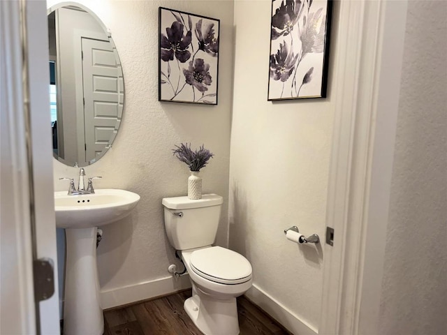 1162 Thicket Ln, New Braunfels, TX 78132 - bathroom featuring wood finished floors, toilet, and baseboards