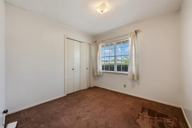 105 E St Johns Ave, Austin, TX 78752 - unfurnished bedroom with carpet, baseboards, and a closet