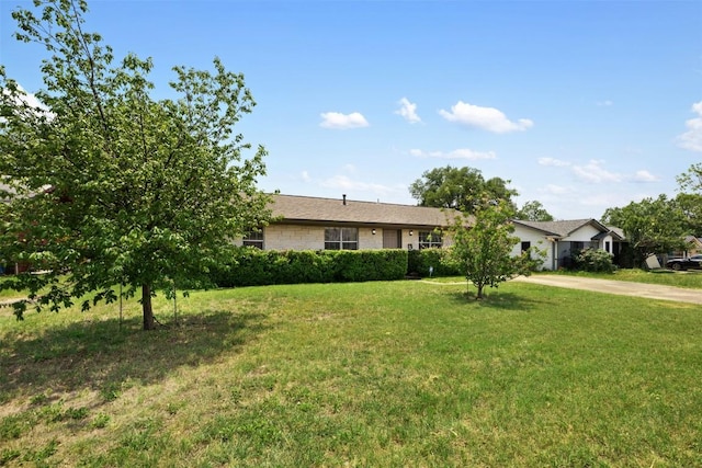 105 E St Johns Ave, Austin, TX 78752 - ranch-style home with a front yard and driveway