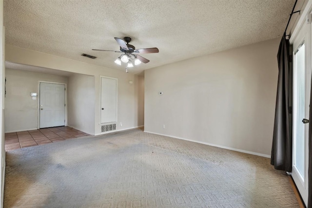 105 E St Johns Ave, Austin, TX 78752 - empty room featuring a ceiling fan, a textured ceiling, carpet flooring, and baseboards