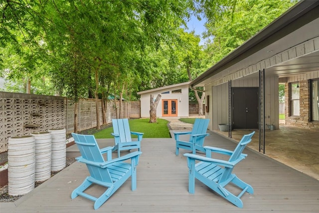 1254 S Church St, Georgetown, TX 78626 - wooden deck with french doors, a fenced backyard, and an outbuilding