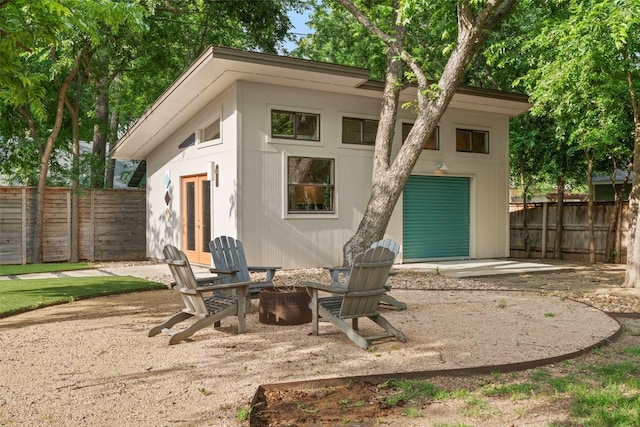 1254 S Church St, Georgetown, TX 78626 - rear view of house with a fire pit, a garage, and french doors