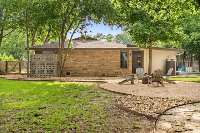 1254 S Church St, Georgetown, TX 78626 - rear view of house with a fire pit and a chimney