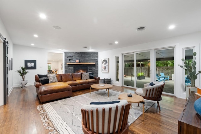 1254 S Church St, Georgetown, TX 78626 - living room with wood finished floors, baseboards, recessed lighting, and a barn door