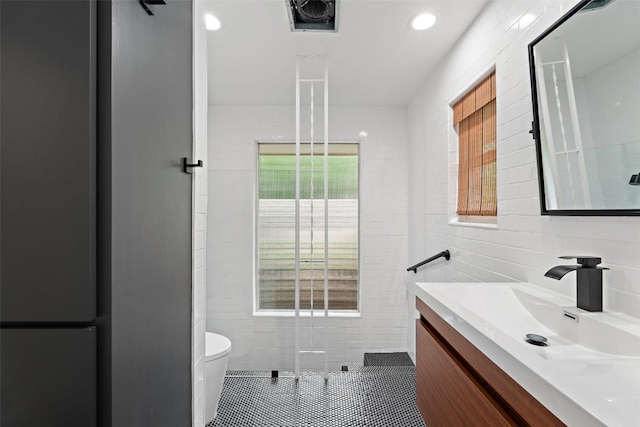 1254 S Church St, Georgetown, TX 78626 - bathroom featuring tile walls, vanity, toilet, recessed lighting, and tile patterned flooring