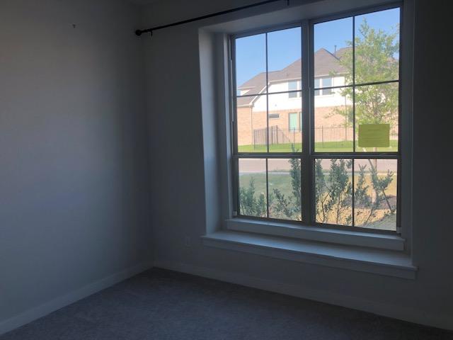 22617 Agave Grove Dr, Lago Vista, TX 78645 - empty room featuring dark carpet and healthy amount of natural light