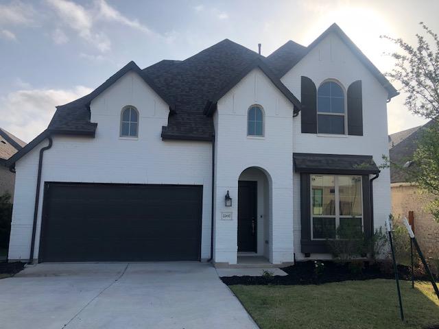 22617 Agave Grove Dr, Lago Vista, TX 78645 - french country inspired facade featuring a garage, driveway, and a shingled roof
