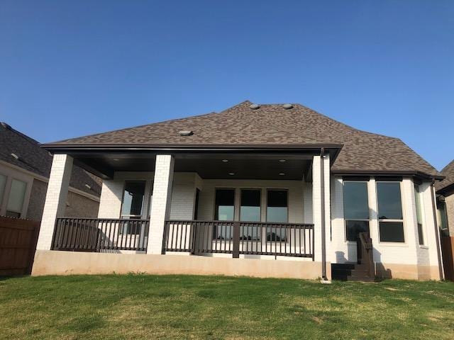 22617 Agave Grove Dr, Lago Vista, TX 78645 - back of property with a yard, a porch, and roof with shingles