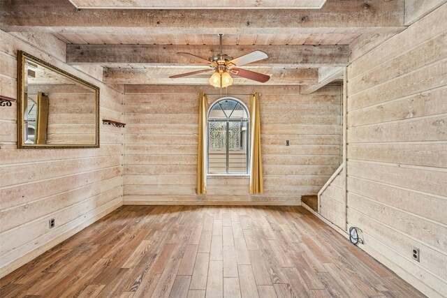 119 Topspin Cir, Spicewood, TX 78669 - spare room with wooden walls, wood ceiling with exposed beams, a ceiling fan, and wood finished floors