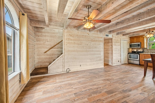 119 Topspin Cir, Spicewood, TX 78669 - unfurnished living room with wooden ceiling with exposed beams, a ceiling fan, light wood-type flooring, plenty of natural light, and wooden walls