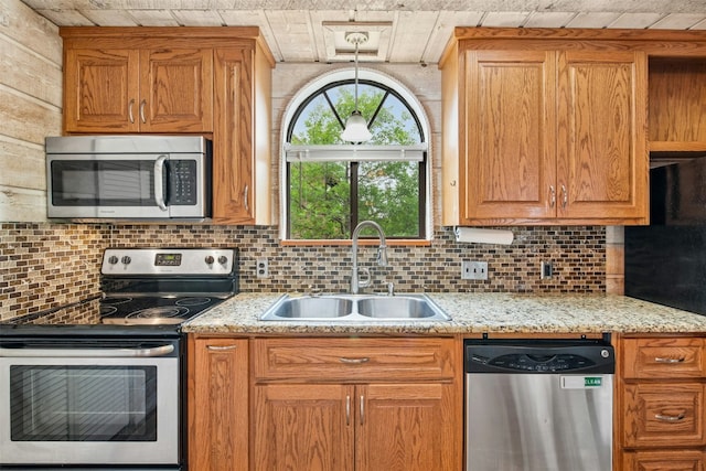 119 Topspin Cir, Spicewood, TX 78669 - kitchen with appliances with stainless steel finishes, a sink, tasteful backsplash, and light stone counters