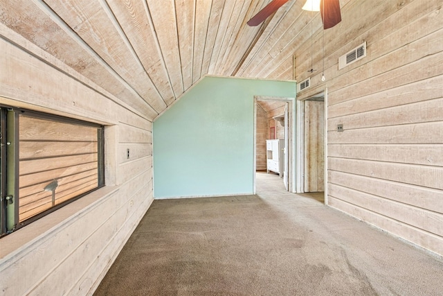 119 Topspin Cir, Spicewood, TX 78669 - empty room with wooden walls, vaulted ceiling, wooden ceiling, carpet floors, and a ceiling fan