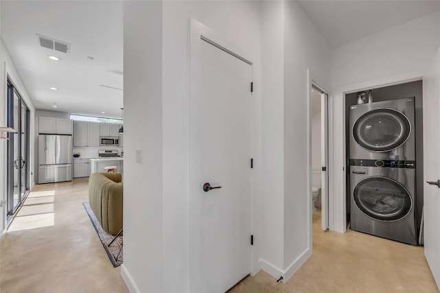 3409 Neal St Unit 2, Austin, TX 78702 - washroom with stacked washer / drying machine, recessed lighting, and baseboards