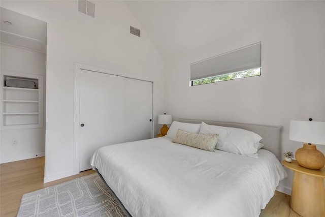 3409 Neal St Unit 2, Austin, TX 78702 - bedroom featuring wood finished floors, a closet, vaulted ceiling, and baseboards