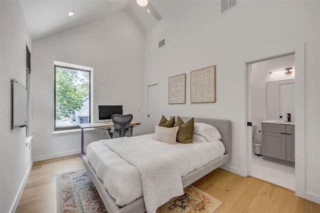3409 Neal St Unit 2, Austin, TX 78702 - bedroom with high vaulted ceiling, an office area, light wood-style flooring, ensuite bathroom, and baseboards