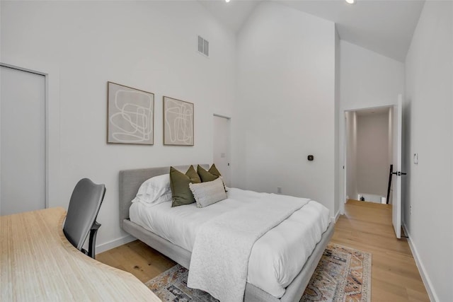 3409 Neal St Unit 2, Austin, TX 78702 - bedroom with high vaulted ceiling, light wood-type flooring, baseboards, and recessed lighting