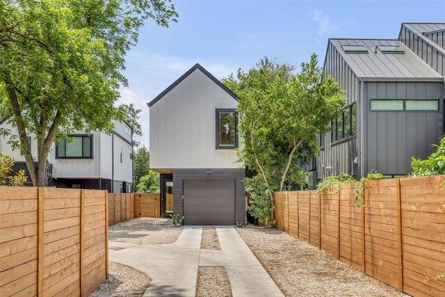 3409 Neal St Unit 2, Austin, TX 78702 - view of home's exterior with concrete driveway, a garage, and a fenced backyard