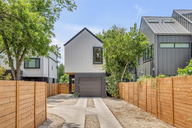 3409 Neal St Unit 2, Austin, TX 78702 - view of side of property featuring driveway, an attached garage, and a fenced backyard