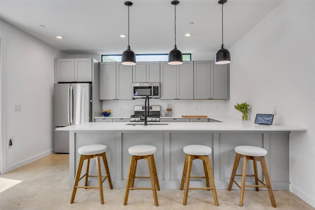3409 Neal St Unit 2, Austin, TX 78702 - kitchen featuring stainless steel appliances, gray cabinetry, baseboards, light countertops, and hanging light fixtures