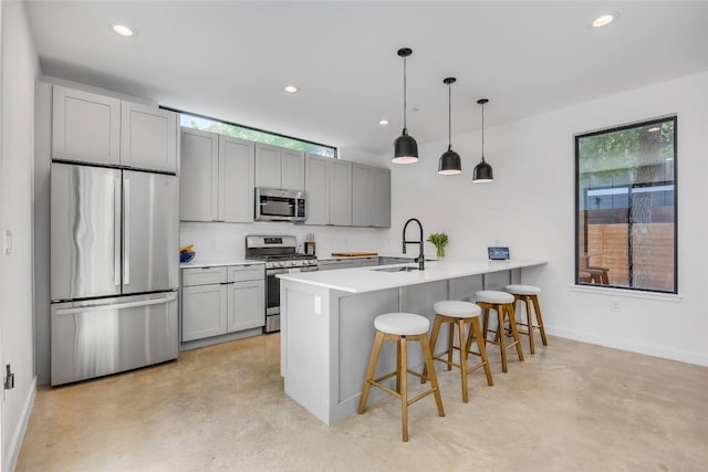 3409 Neal St Unit 2, Austin, TX 78702 - kitchen with appliances with stainless steel finishes, a sink, concrete floors, a breakfast bar, and baseboards
