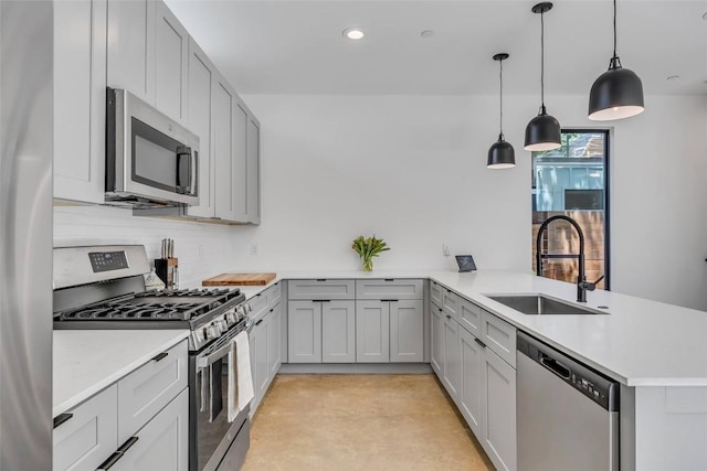 3409 Neal St Unit 2, Austin, TX 78702 - kitchen featuring appliances with stainless steel finishes, a sink, a peninsula, light countertops, and backsplash
