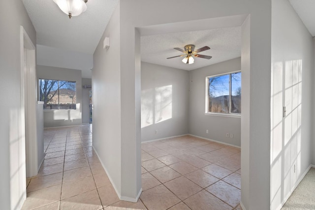 16901 Dashwood Creek Dr, Pflugerville, TX 78660 - hallway with a textured ceiling and light tile patterned floors