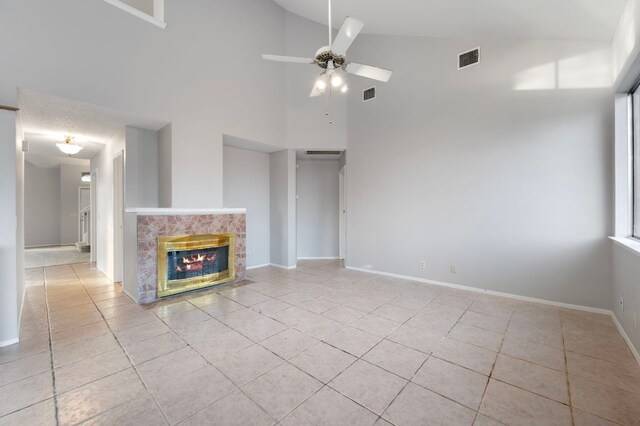 16901 Dashwood Creek Dr, Pflugerville, TX 78660 - unfurnished living room featuring high vaulted ceiling, tile patterned floors, a ceiling fan, a tile fireplace, and baseboards