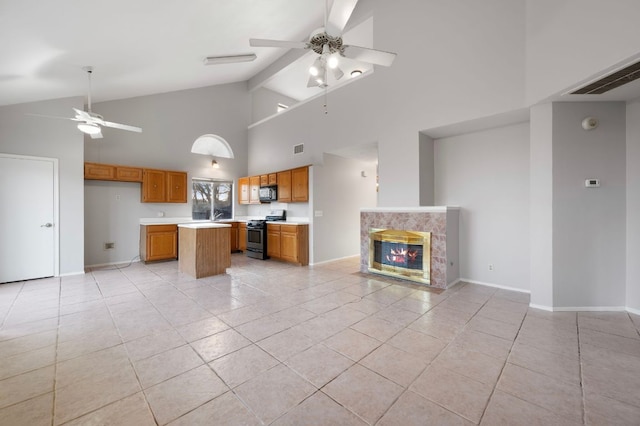 16901 Dashwood Creek Dr, Pflugerville, TX 78660 - kitchen with ceiling fan, black appliances, light tile patterned flooring, open floor plan, and high vaulted ceiling
