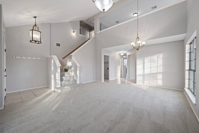 16901 Dashwood Creek Dr, Pflugerville, TX 78660 - unfurnished living room with a chandelier, carpet flooring, stairs, high vaulted ceiling, and baseboards