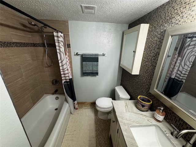 2425 Ashdale Dr Unit 101, Austin, TX 78757 - full bathroom featuring shower / bath combo, a textured ceiling, toilet, and vanity