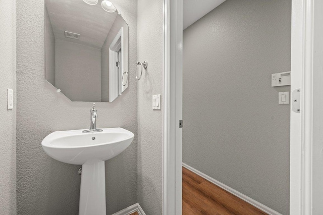 141 Snowy Egret Ln, Leander, TX 78641 - bathroom featuring wood finished floors and baseboards
