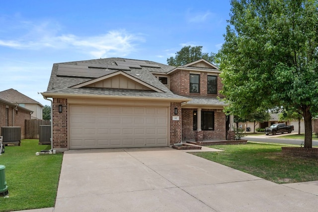 141 Snowy Egret Ln, Leander, TX 78641 - view of front of home with roof mounted solar panels, driveway, an attached garage, brick siding, and central AC