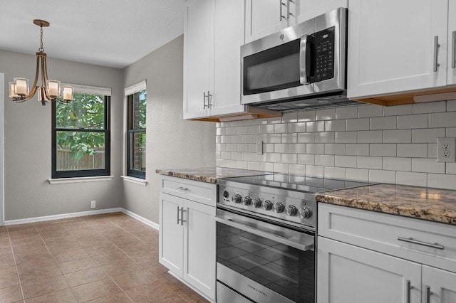 141 Snowy Egret Ln, Leander, TX 78641 - kitchen with stainless steel appliances, decorative backsplash, white cabinets, and a chandelier